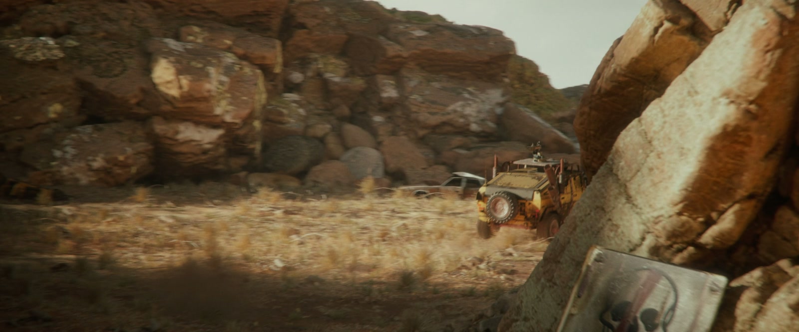 An armored vehicle framed by canyon walls